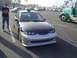 2002 Ford Taurus - Sedan with aftermarket front bumper and hood modification in a parking lot.