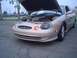 2002 Ford Taurus - A tan Mercury Sable is parked with its hood up, revealing the engine compartment.