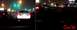 2002 Ford Taurus - A white 2002 Ford Taurus is seen from behind while driving on a highway at night, with other vehicles and city lights in the background.