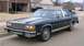 1985 Ford Crown Victoria LTD - This sedan is parked in front of a brick house with an open garage.