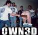 1990 Ford Bronco - A group of men are gathered in a room, with one man holding a paddle over another's exposed buttocks.