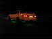 1995 Ford Taurus - A yellow 1995 Ford Taurus sedan with green underglow is parked at night, viewed from the rear.