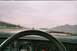 1985 Ford Mustang - Driving on a highway with traffic visible from the car's interior.