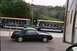 1985 Ford Mustang - A black convertible is parked near Universal Studios trams.