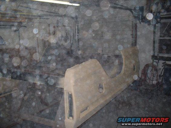 Truck fender and bed panel in a garage, possibly undergoing restoration