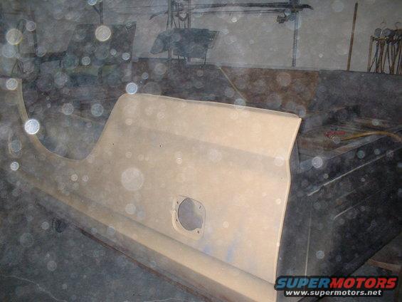 Beige truck door panel with circular cutout