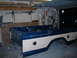 1978 Ford F-250 - A pickup truck bed is shown on jack stands inside a garage, with tools on the wall behind it.
