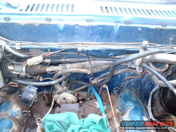 close-up of engine bay with hoses and wires