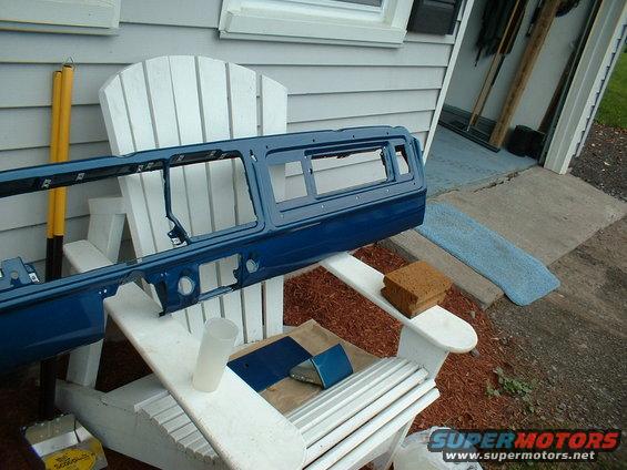 Blue dashboard frame resting on Adirondack chair
