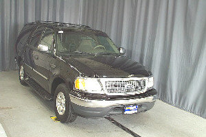 Black Ford Expedition SUV, front passenger side view. Likely 2000-2002 model