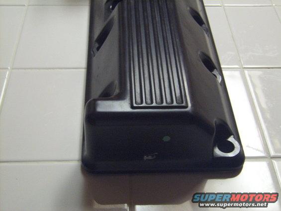 Black valve cover with ribbed detail and mounting holes