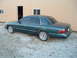 1995 Mercury Grand Marquis - A 1995 Mercury Grand Marquis is parked on a gravel lot in front of a metal building.