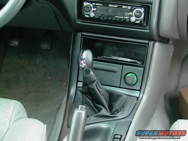 Car interior showing gear shift, Pioneer stereo, and green illuminated button