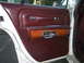 1988 Mercury Grand Marquis - Interior door panel of a 1988 Mercury Grand Marquis, maroon upholstery and wood grain trim.