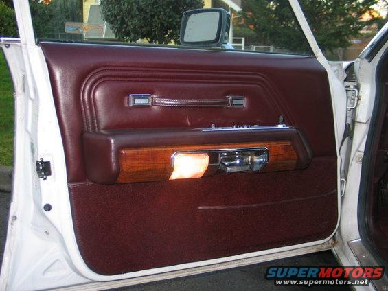 1988 Mercury Grand Marquis interior door panel with wood trim and maroon upholstery