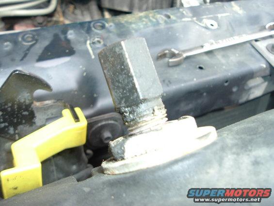 Radiator cap fitting with wrench on black metal support