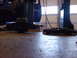 1998 Volkswagen Jetta - Two car parts are on the floor of a garage, near a vehicle and a lift.