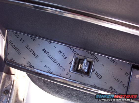 Interior door panel with window switch and protective film
