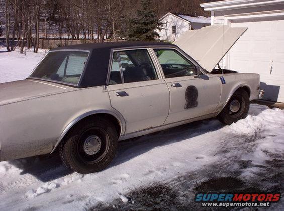 1979 Dodge St. Regis police car with hood open, parked in snow