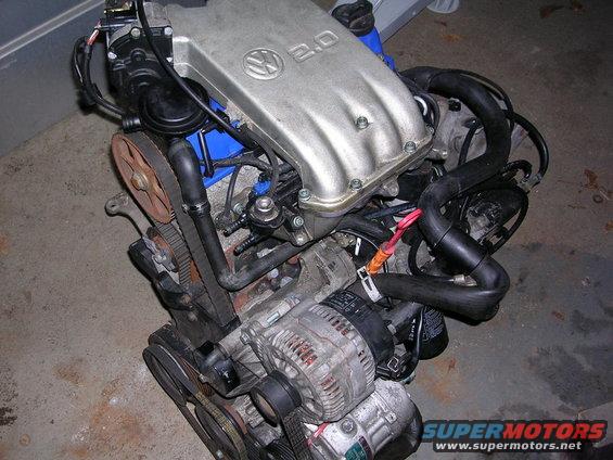 Volkswagen 2.0 engine with silver valve cover, alternator, and timing belt