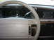 1992 Ford Crown Victoria - The interior of a 1992 Ford Crown Victoria shows a digital dashboard and a beige steering wheel.