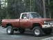 1981 Chevrolet C/K Pickup - This lifted pickup truck, likely from the late 1970s, is parked outdoors with trees in the background.