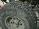 1981 Chevrolet C/K Pickup - This is a close-up of a tire, likely for an off-road vehicle, covered in mud.