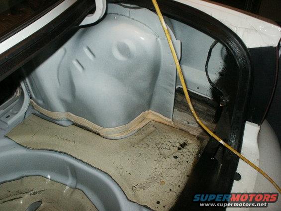 Trunk interior showing sound dampening material and yellow wire