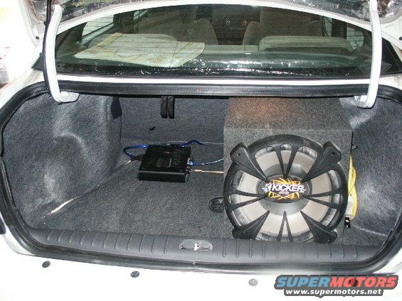 Car trunk interior with Kicker subwoofer, amplifier, and sound dampening material
