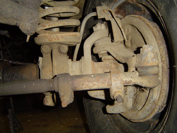 Front suspension and brake assembly with coil spring and tie rod