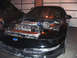 1994 Ford Probe - Front view of a black car with its engine exposed, revealing a turbocharger and Ford emblem.