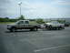 1964 Mercury Comet - Ford F-250 tows a 1964 Mercury Comet on a dual-axle trailer in a parking lot.