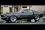 1969 Ford Mustang Boss 302, dark green, side view, wet pavement