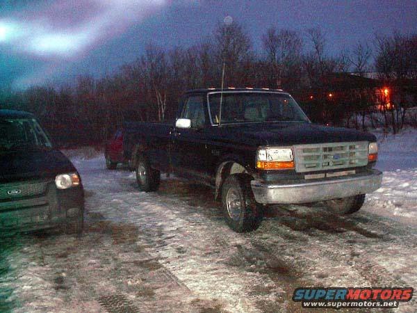 1993 Ford F-150 pickup truck parked in snow next to another vehicle