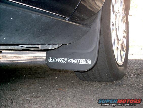 Black mud flap with "CROWN VICTORIA" text on a vehicle