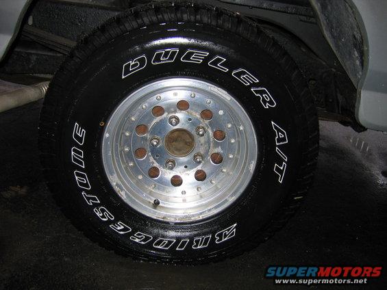 Bridgestone Dueler A/T tire on a multi-lug aluminum wheel