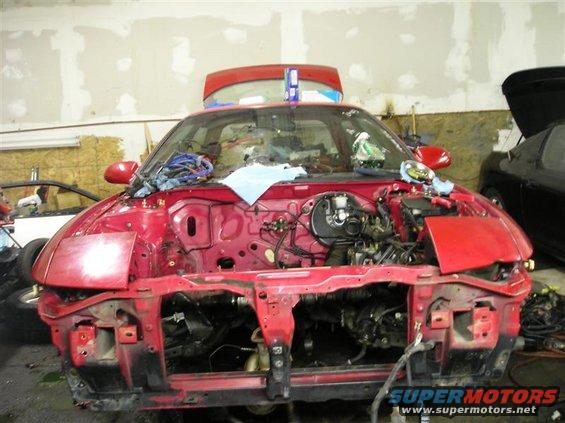 1994 Ford Probe front end disassembled in garage, engine bay exposed