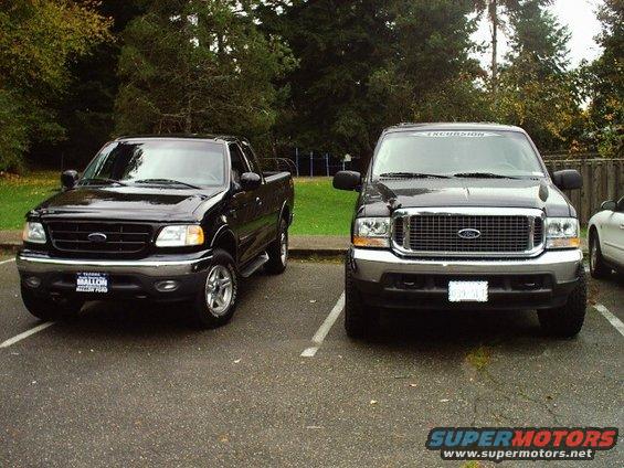 Black 2002 Ford F-150 parked next to a black Ford Excursion, front view