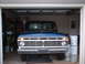 1973 Ford F-100 - Front view of a blue 1973 Ford F-100 truck parked inside a garage, with the word "FORD" visible on the grille.