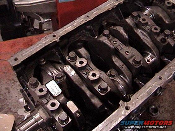 Engine block with crankshaft and connecting rods visible. Some labels are on the connecting rods