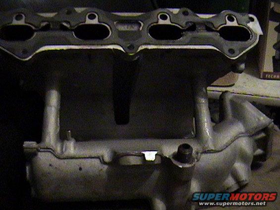 Aluminum intake manifold with gasket mating surface visible