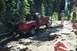 1992 Ford F-150 - A red 1992 Ford F-150 navigates a challenging, rocky off-road trail surrounded by trees.