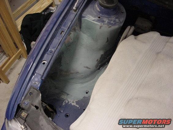 Blue 1998 Volkswagen Jetta engine bay strut tower with body filler
