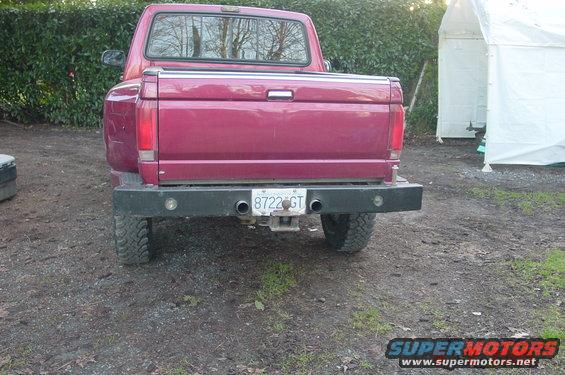 Red 1992 Ford F-150 rear view with dual exhaust and custom bumper