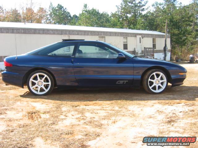 Blue 1993 Ford Probe GT parked outside a trailer home