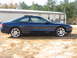1993 Ford Probe - A blue Ford Probe GT is shown from the side, parked on a dirt lot in front of a trailer.