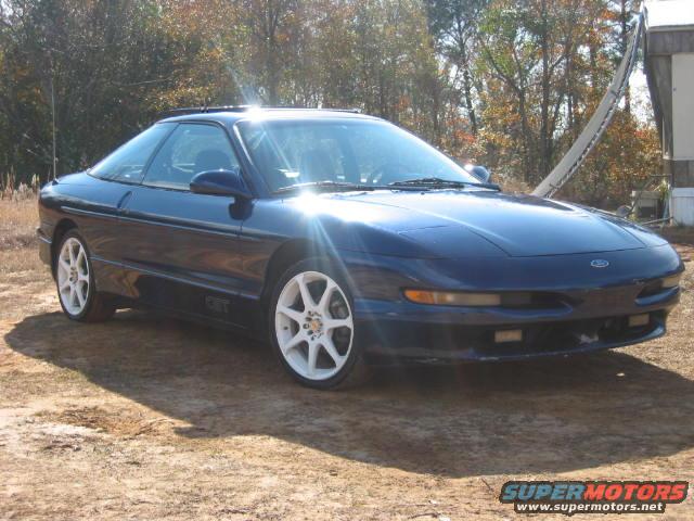 Blue 1993 Ford Probe GT with white wheels parked outdoors