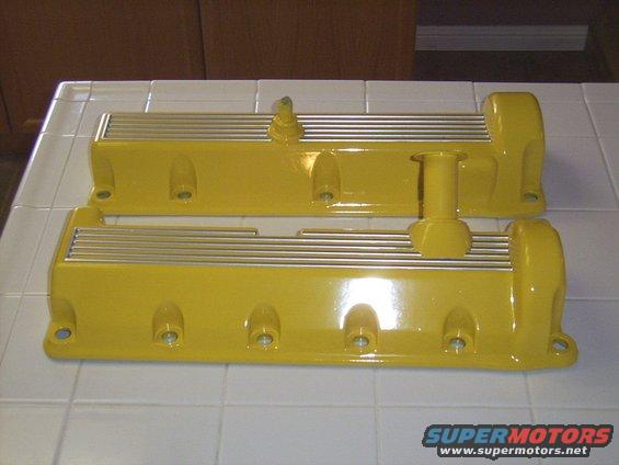 Yellow valve covers with silver fins and mounting holes