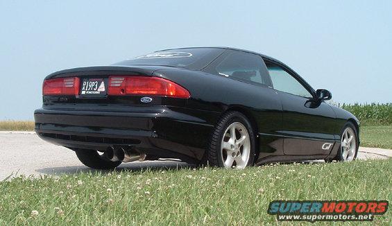 Black coupe with dual exhaust and 'GT' badge, rear view. License plate reads P19P3