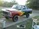 1978 Ford Bronco - This truck features a striking flame graphic design on its side, with a red front fading into a black rear.
